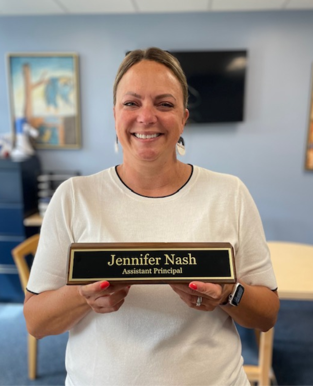 Jennifer Nash, assistant principal, poses with her nameplate displaying her new title. 